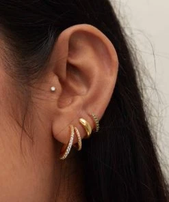 Astridandmiyu Best Sellers May Birthstone Huggies In Gold With Emerald CZ